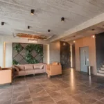 Lobby lounge with green feature wall and staircase