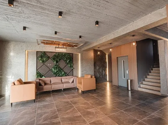 Lobby lounge with green feature wall and staircase