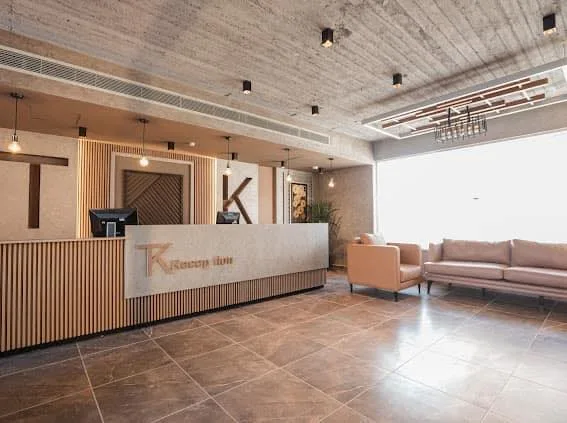 Reception desk with TK lettering and lobby seating