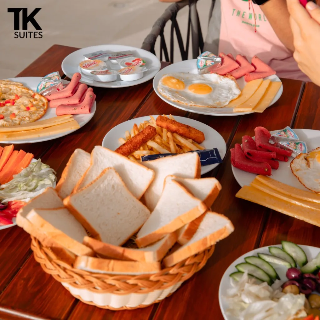 Breakfast spread with eggs, cheese and bread at TK Suites