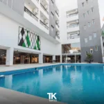 TK Suites swimming pool and courtyard on a sunny day