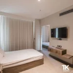 Bright suite with bed, TV and seating area